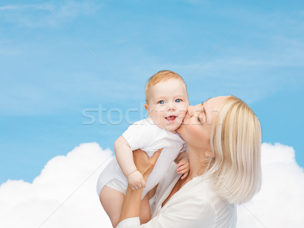 happy mother kissing smiling baby Stock photo © dolgachov