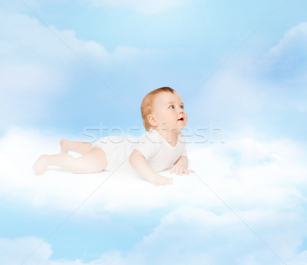 smiling baby lying on cloud and looking up Stock photo © dolgachov