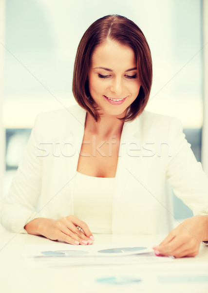 businesswoman working with graphs in office Stock photo © dolgachov