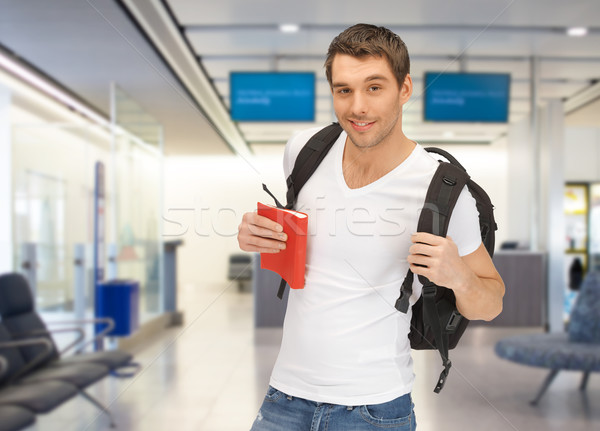 smiling student with backpack and book at airport Stock photo © dolgachov