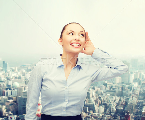 Stock photo: smiling businesswoman listening gossig