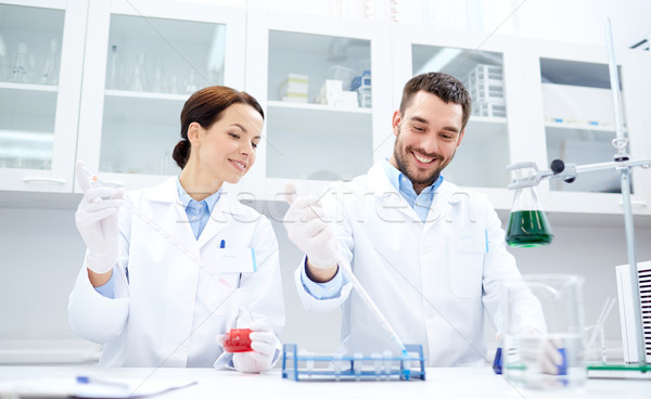 young scientists making test or research in lab Stock photo © dolgachov