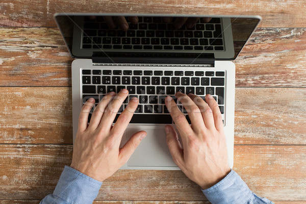 close up of male hands with laptop typing Stock photo © dolgachov