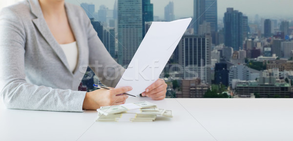 close up of female hands with money and tax report Stock photo © dolgachov