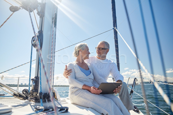 Stock photo: senior couple with tablet pc on sail boat or yacht