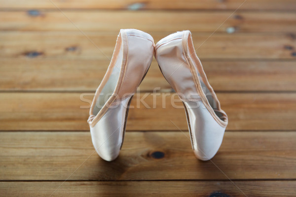 close up of pointe shoes on wooden floor Stock photo © dolgachov