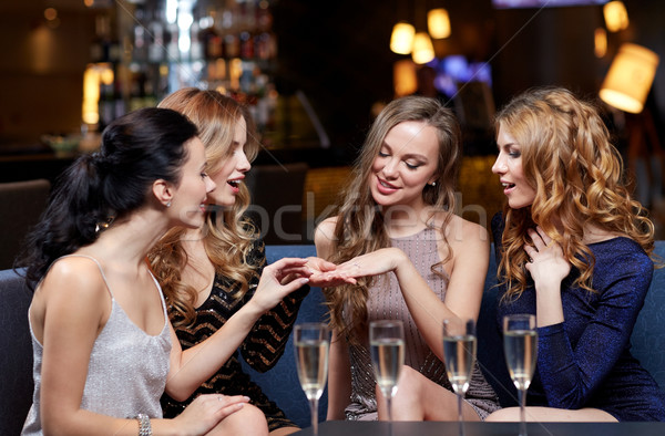 woman showing engagement ring to her friends Stock photo © dolgachov