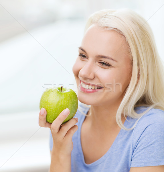 happy woman eating green apple at home Stock photo © dolgachov