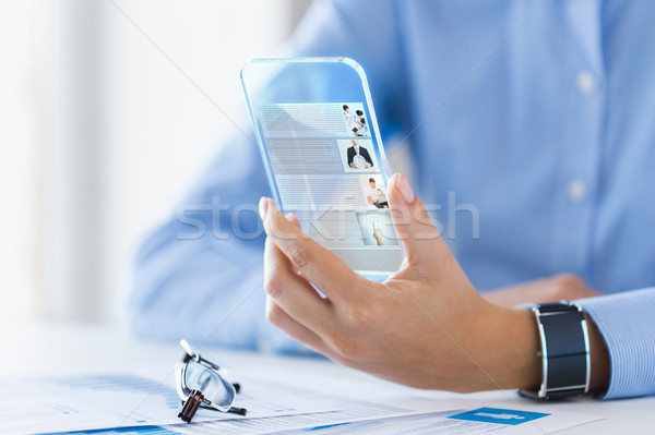 close up of woman with transparent smartphone Stock photo © dolgachov