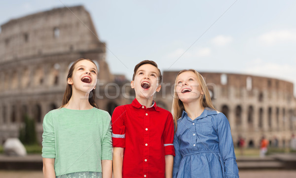 Stock photo: amazed children looking up over coliseum in rome
