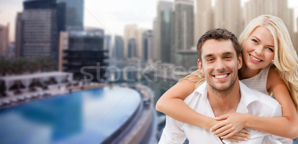 happy couple having fun over dubai city background Stock photo © dolgachov