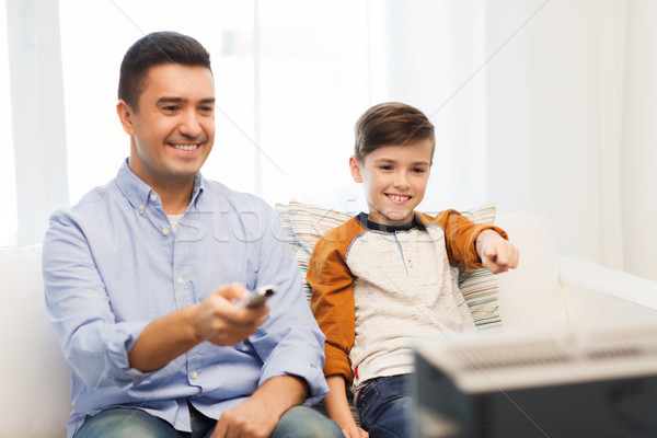 Souriant père en fils regarder tv maison famille [[stock_photo]] © dolgachov