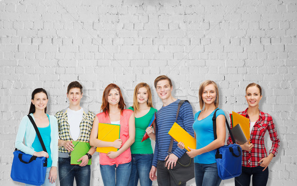 group of teenage students with folders and bags Stock photo © dolgachov