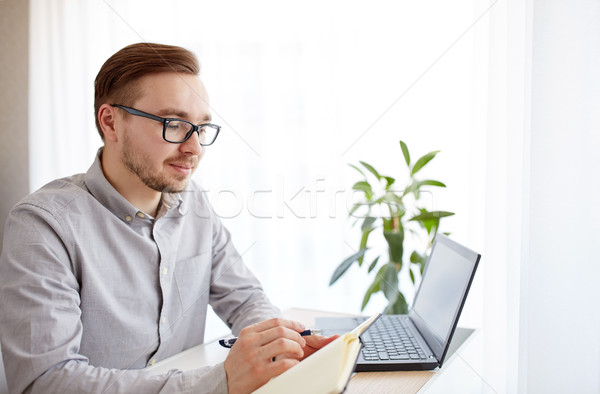 Stock photo: creative man or businessman writing to notebook