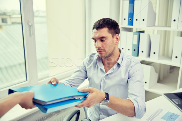 businessman taking folder from secretary in office Stock photo © dolgachov