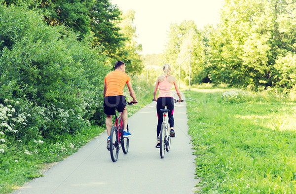 Stock photo: happy couple riding bicycle outdoors