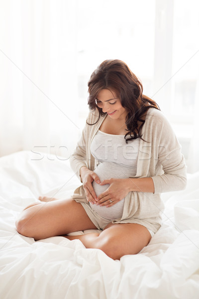 Mutlu hamile kadın kalp jest ev Stok fotoğraf © dolgachov