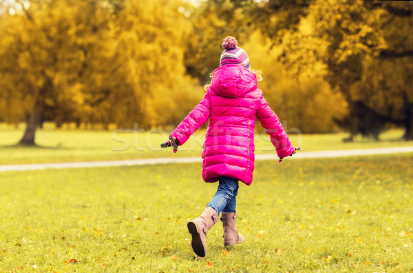 happy little girl running in autumn park Stock photo © dolgachov
