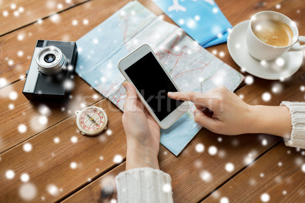 close up of traveler hands with smartphone and map Stock photo © dolgachov