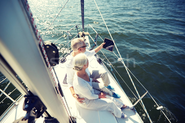 Stock photo: senior couple with tablet pc on sail boat or yacht