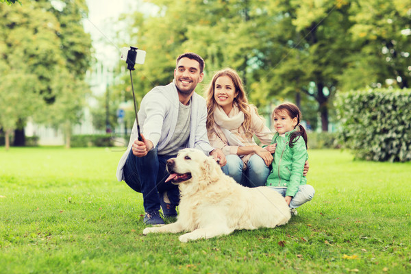 happy family with dog taking selfie by smartphone Stock photo © dolgachov