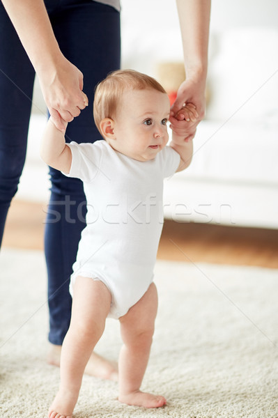 Szczęśliwy baby nauki chodzić matka pomoc Zdjęcia stock © dolgachov