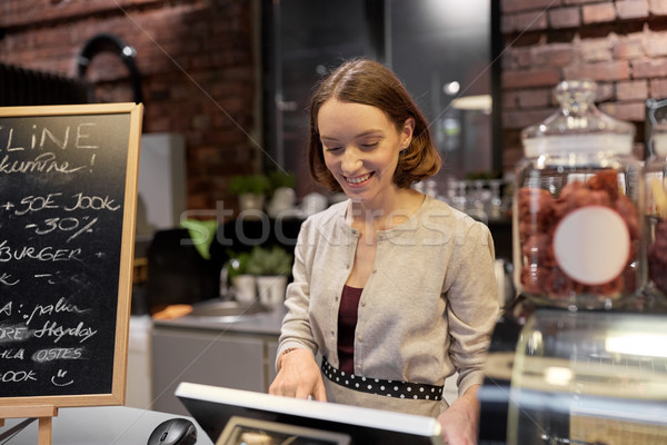 happy woman or barmaid with cashbox at cafe Stock photo © dolgachov