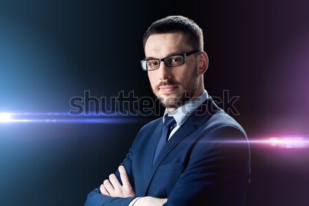 businessman in glasses over black Stock photo © dolgachov
