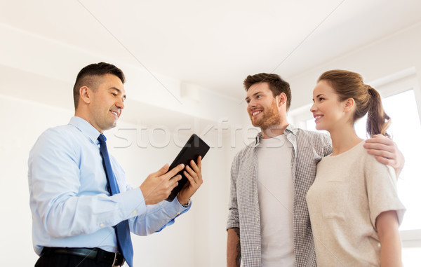 couple and realtor with tablet pc at new home Stock photo © dolgachov