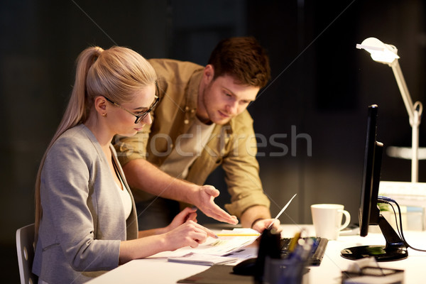 business team with papers working at night office Stock photo © dolgachov