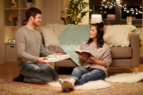 happy couple with book and food at home Stock photo © dolgachov