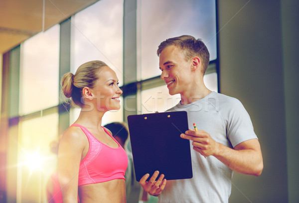 Sorridente mulher jovem personal trainer ginásio fitness esportes Foto stock © dolgachov