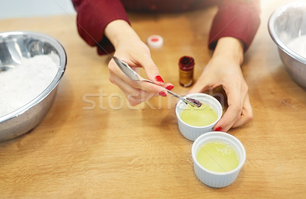 chef adding food color into bowl with egg whites Stock photo © dolgachov