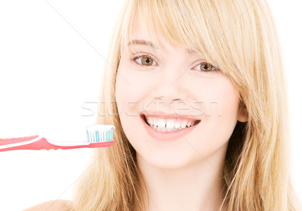 Stock photo: happy girl with toothbrush