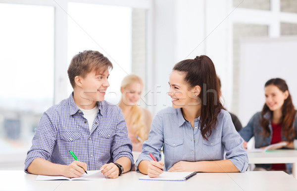 two teenagers with notebooks at school Stock photo © dolgachov