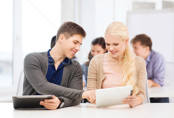 students looking at tablet pc in lecture at school Stock photo © dolgachov