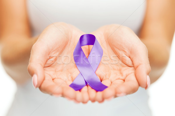 hands holding purple awareness ribbon Stock photo © dolgachov