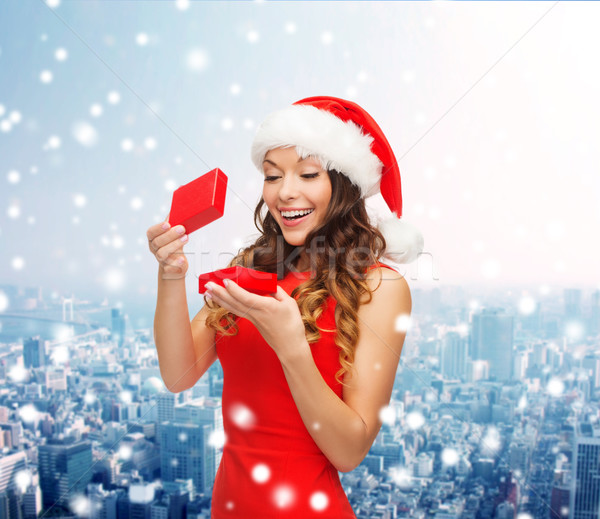 Stock photo: smiling woman in santa helper hat with gift box