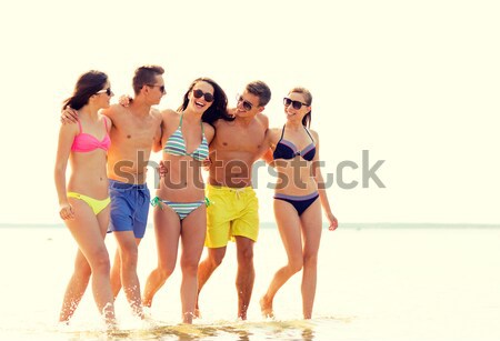 Stock photo: group of smiling women photographing on beach