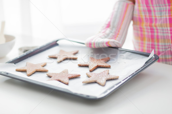 close up of woman with cookies on oven tray Stock photo © dolgachov