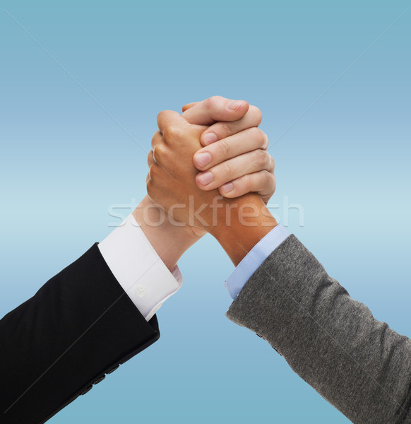 close up of two hands multiracial armwrestling Stock photo © dolgachov