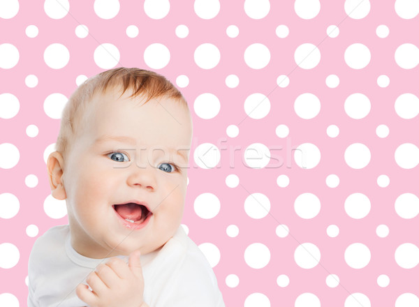 smiling baby girl face over pink polka dots Stock photo © dolgachov