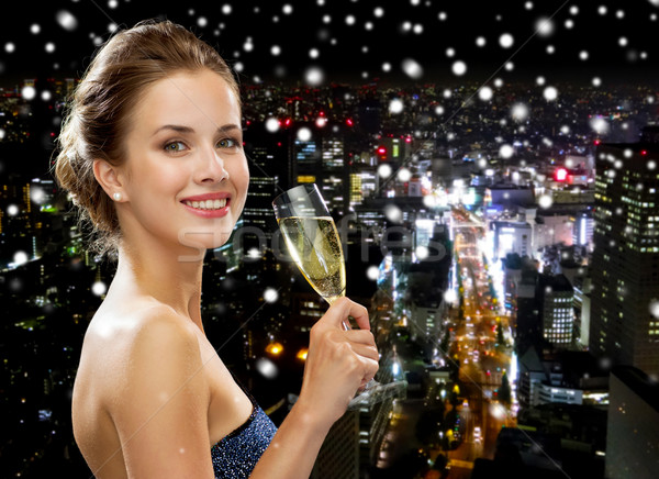 smiling woman holding glass of sparkling wine Stock photo © dolgachov