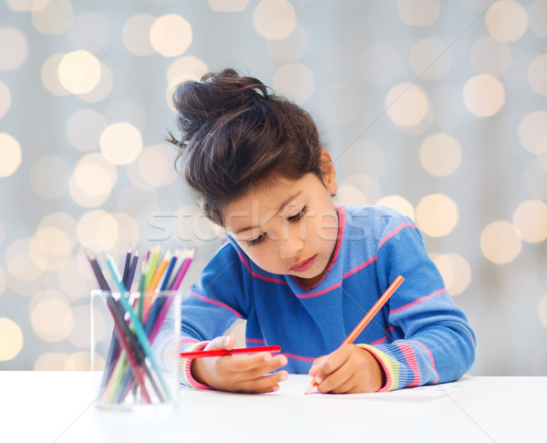 little girl drawing Stock photo © dolgachov