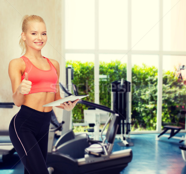 smiling sporty woman with tablet pc computer Stock photo © dolgachov