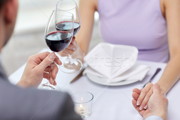 young couple with glasses of wine at restaurant Stock photo © dolgachov