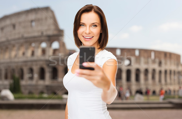 woman taking selfie with smartphone over coliseum Stock photo © dolgachov