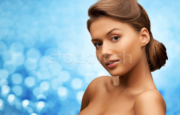 woman with bare shoulders over blue lights Stock photo © dolgachov