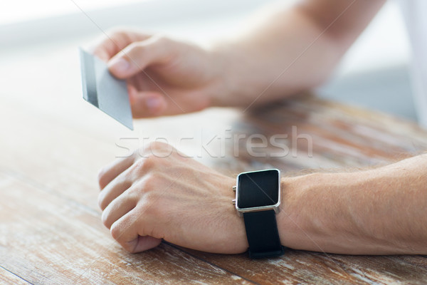 close up of hands with smart watch and credit card Stock photo © dolgachov