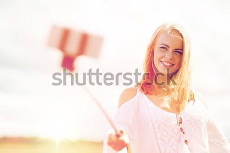 Stock photo: smiling businesswoman or student calling on phone